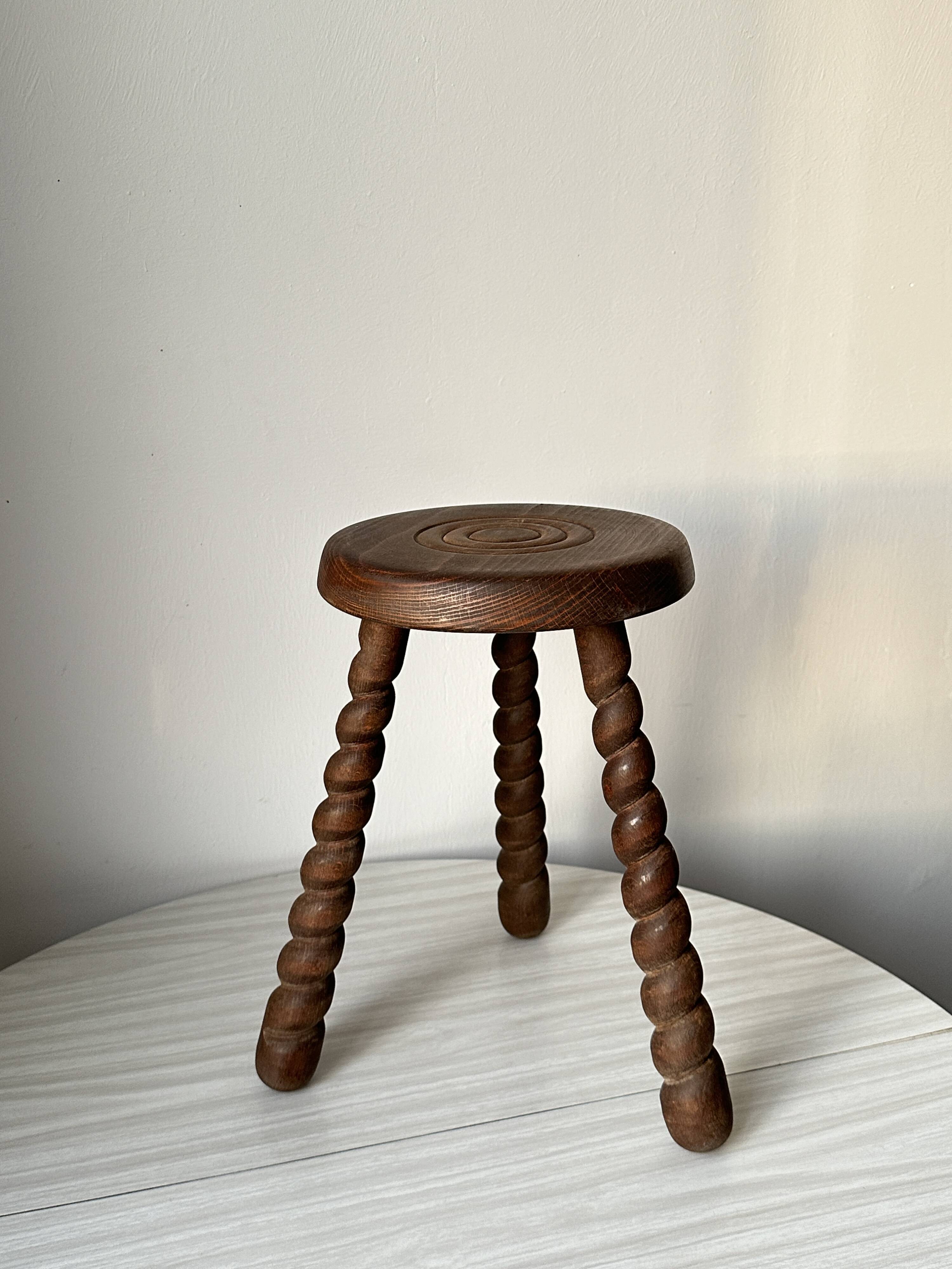 Wooden stool with three twisted legs