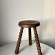 Wooden stool with three twisted legs