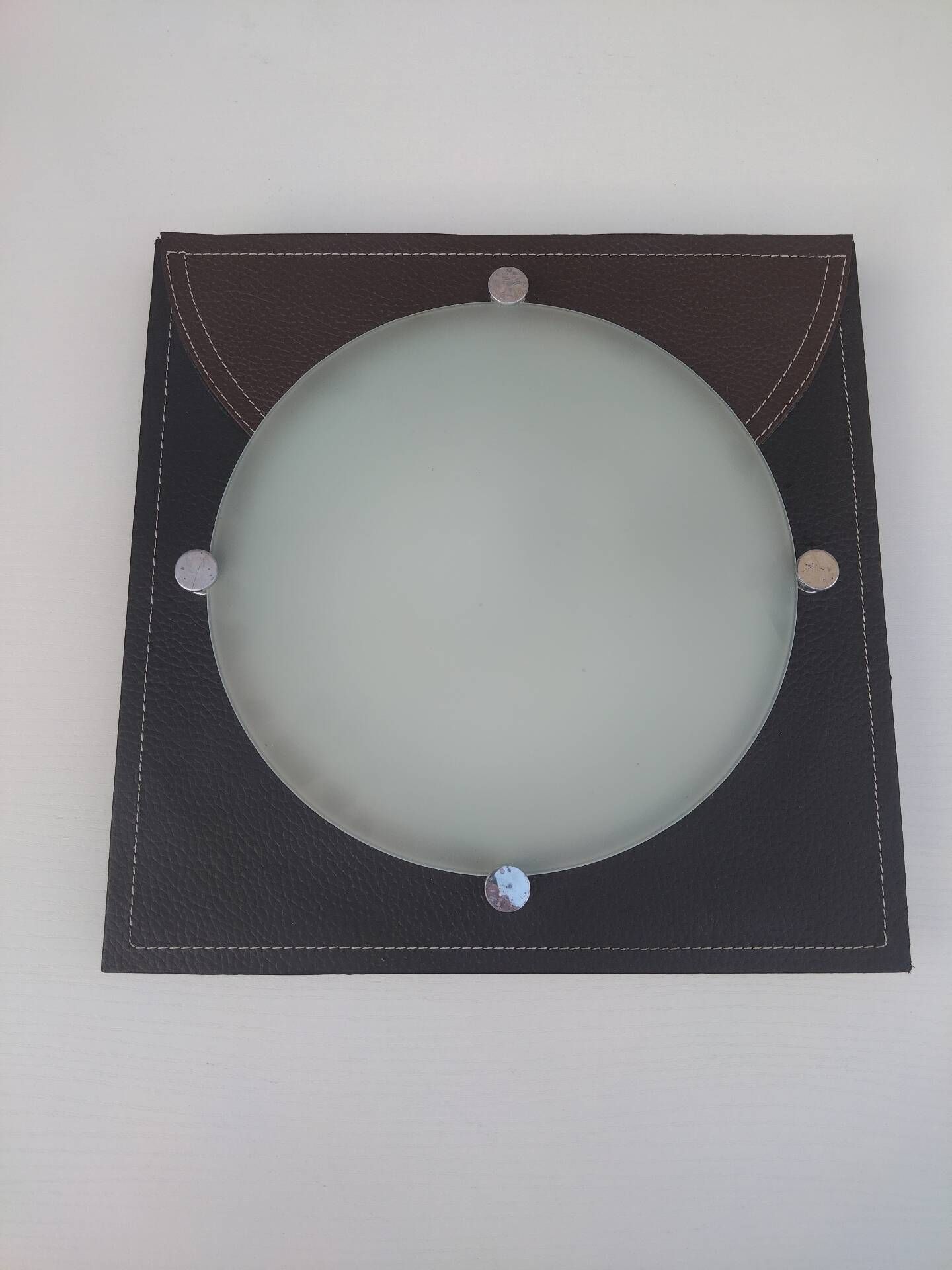 Wall light or ceiling light in frosted glass and leather-like material.