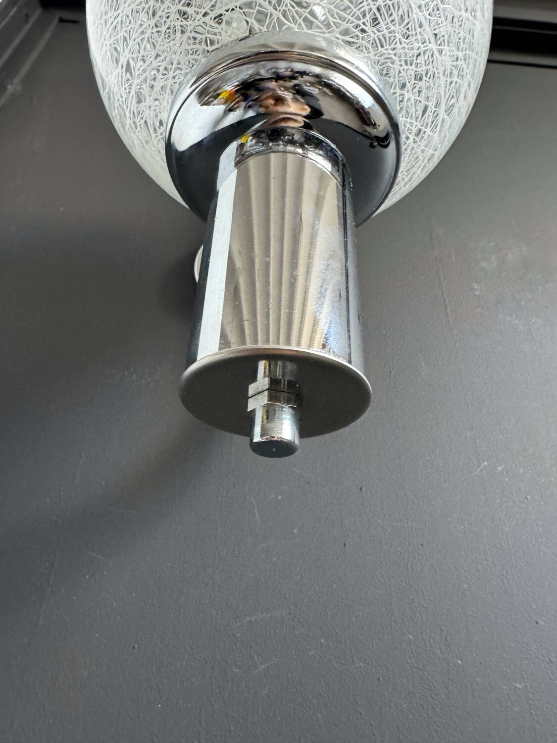 Chrome wall light with blown glass from the 1970s.