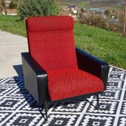 Pair of vintage armchairs in black faux leather and red fabric.