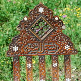 A folding chair and a carved Syrian table with 19th-century mother-of-pearl inlays.