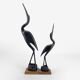 Pair of cranes in carved horn design Mid-Century