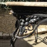 Wrought iron table with openwork flower belt. marble top