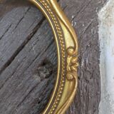Stylized oval gold frame
