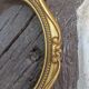 Stylized oval gold frame