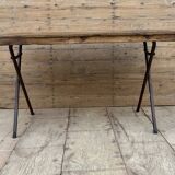 Folding workshop table with a metal frame and solid teak top.