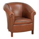 Cowhide club armchair in English style with comfortable seating.