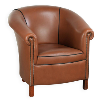 Cowhide club armchair in English style with comfortable seating.