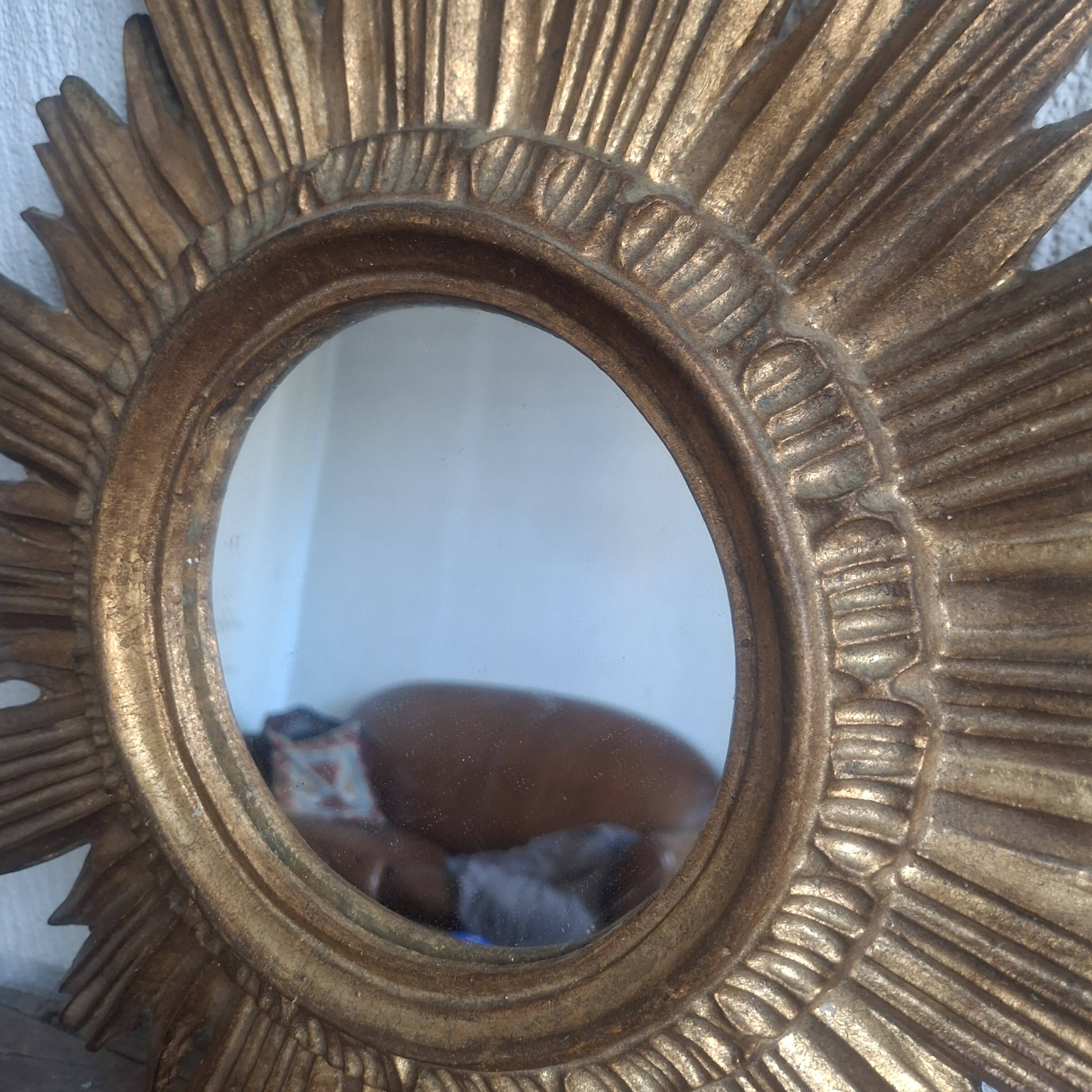 Vintage sun mirror in gilded wood. 1960