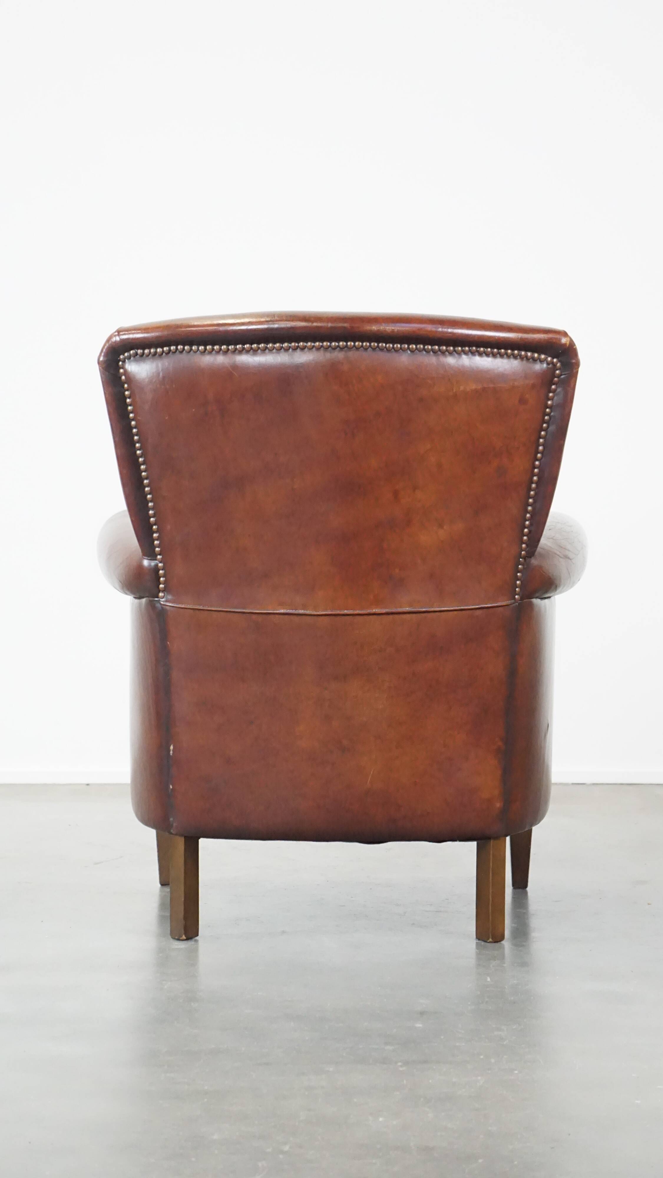 Sheep leather armchair correctly finished with decorative nails