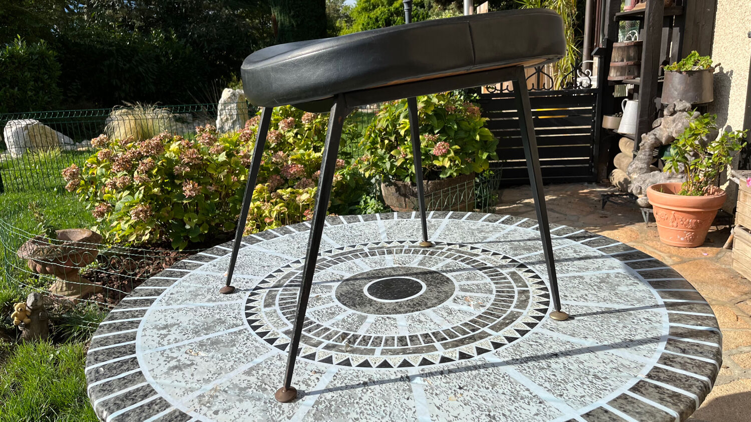 Low black leatherette stool from the 60s/70s