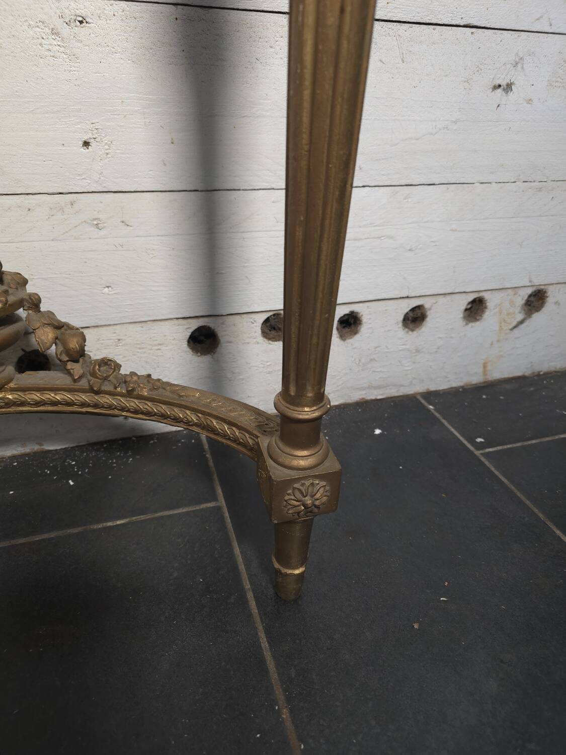 Louis XVI style console in gilded wood with a marble top.