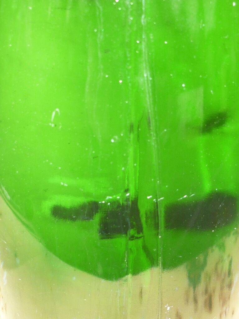 Green blown glass bottle of 58 cm.