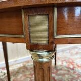 Round dining table with leather top in Louis XVI style.
