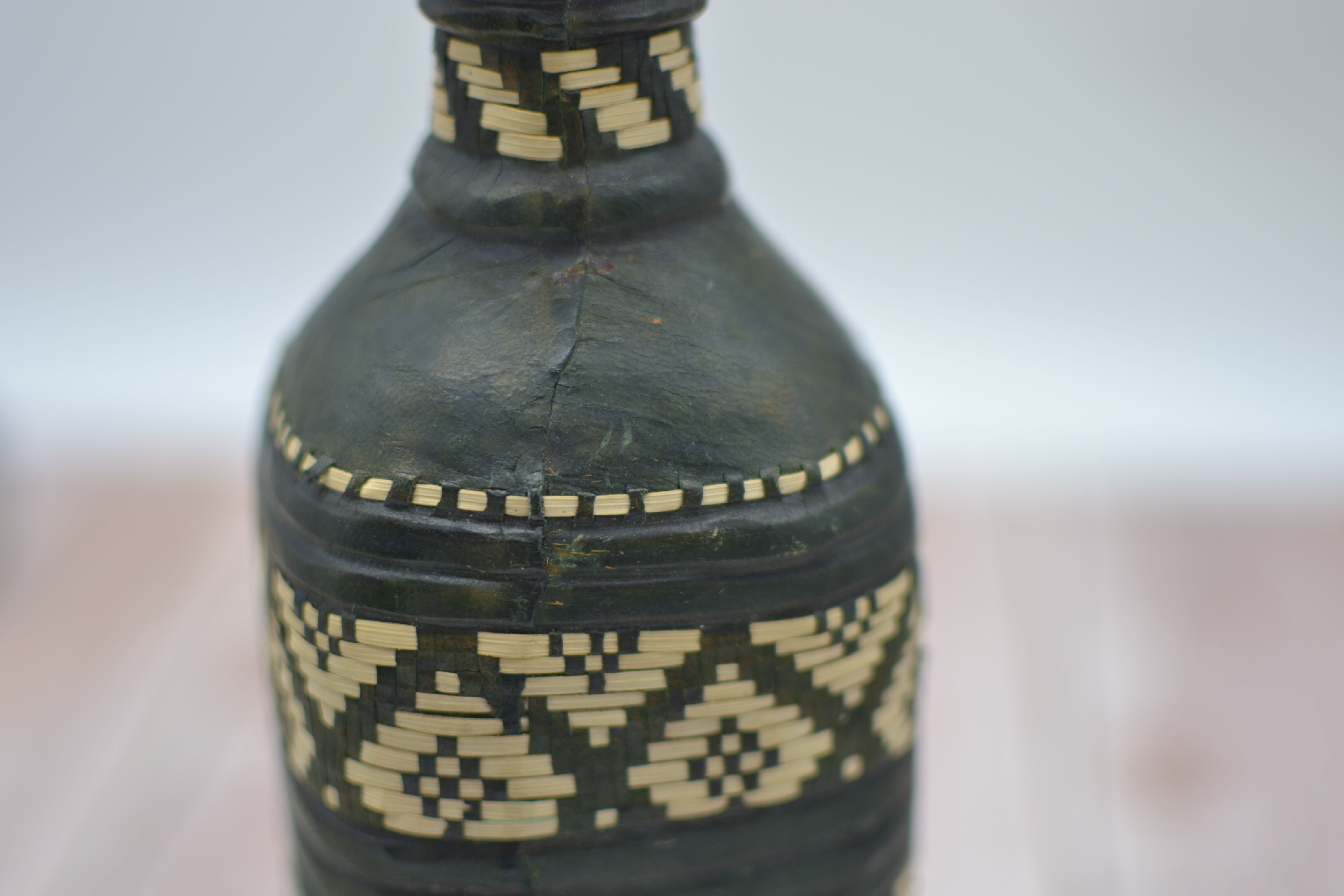Set of 2 decorative vintage bottles covered with leather & wicker