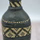 Set of 2 decorative vintage bottles covered with leather & wicker