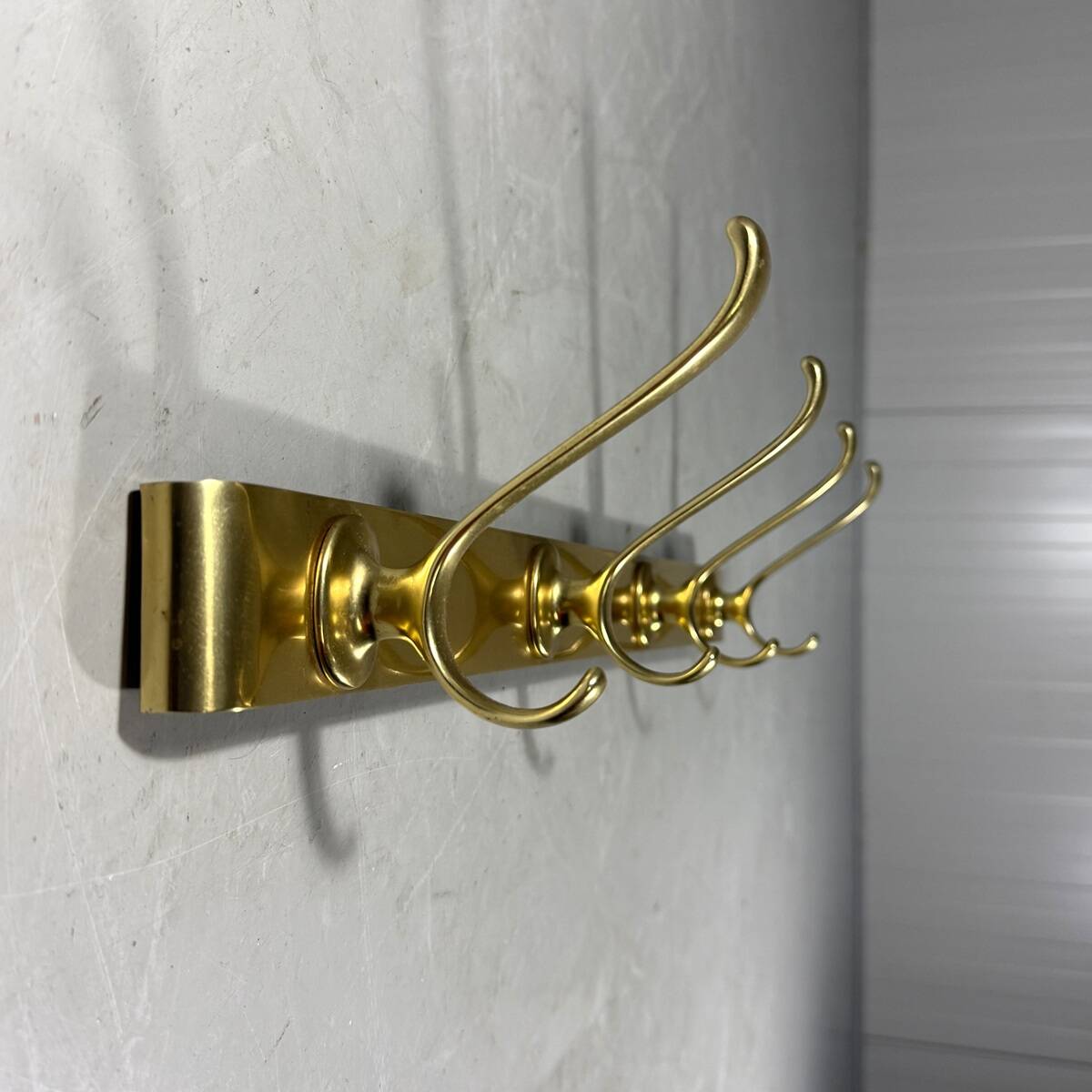 Gold coloured aluminium wall coat rack 1960’s