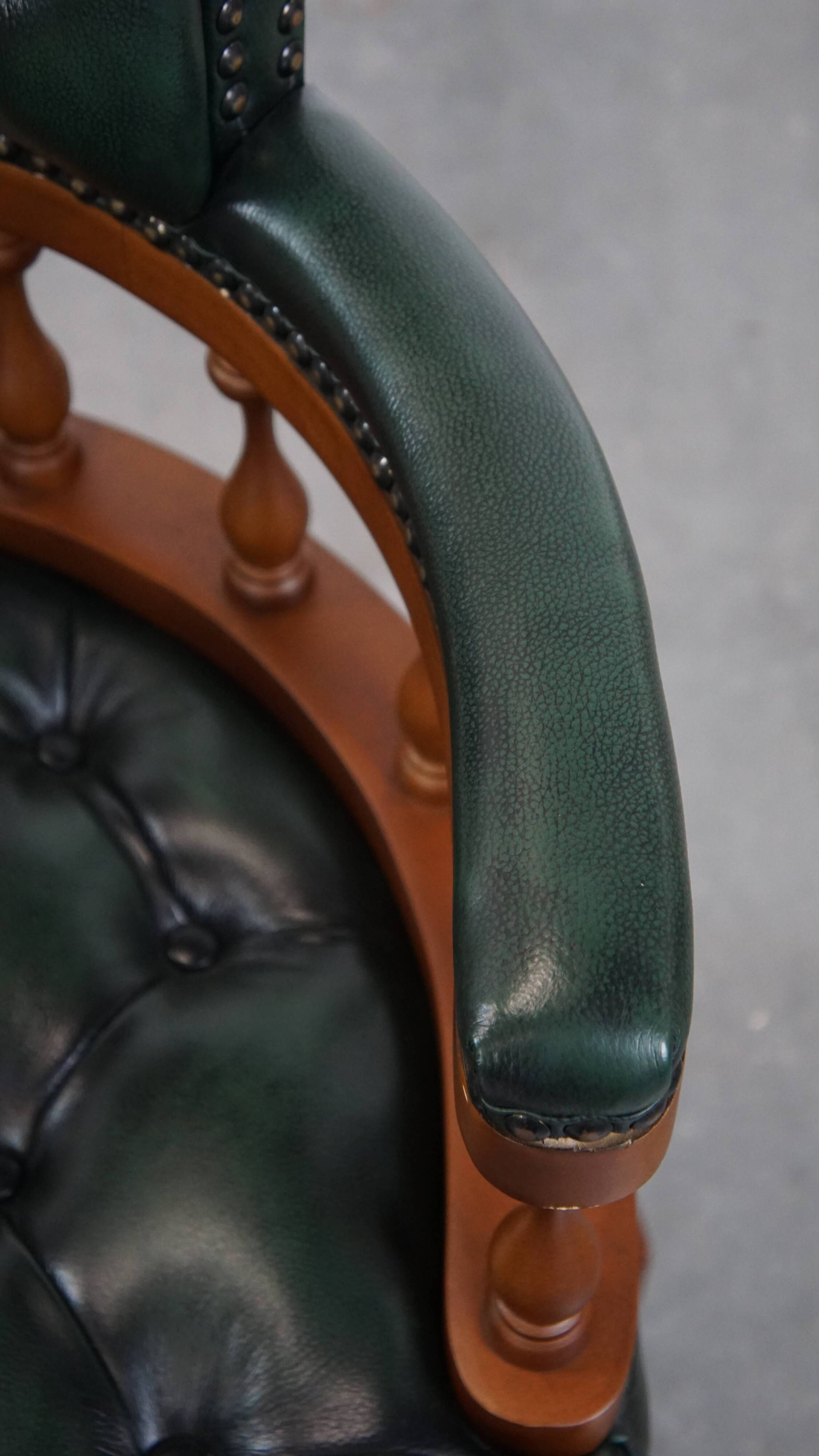 Dark green chesterfield office chair in cowhide leather on wheels