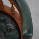 Dark green leather Chesterfield office chair on wheels.