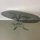 Vintage coffee table from the 70s in smoked glass and chrome, oval, Space Age style.