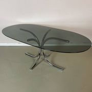 Vintage coffee table from the 70s in smoked glass and chrome, oval, Space Age style.