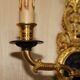 Pair of L'Originale wall sconces plated with 24-carat gold featuring four bronze candles.