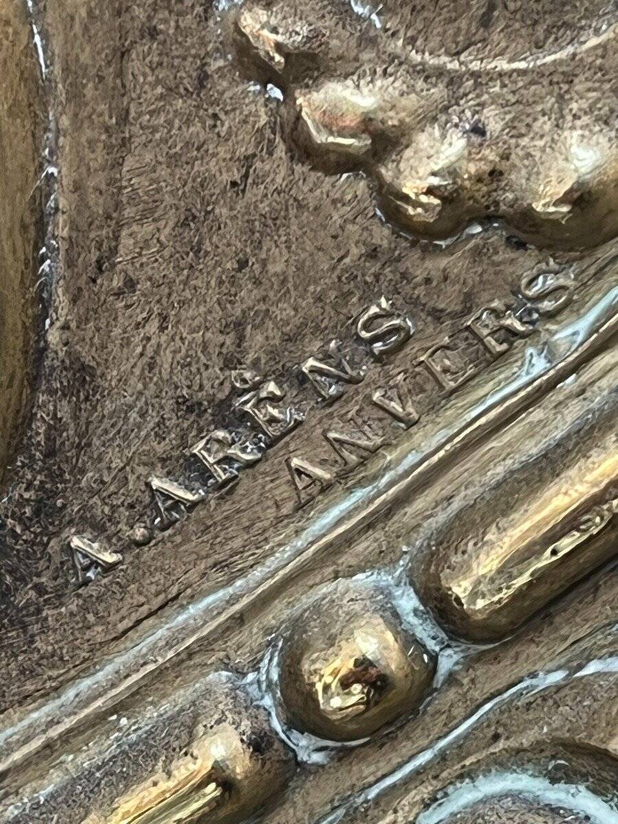 A. Arens, Antwerp, important oval mirror in repoussé brass with numerous animal decorations