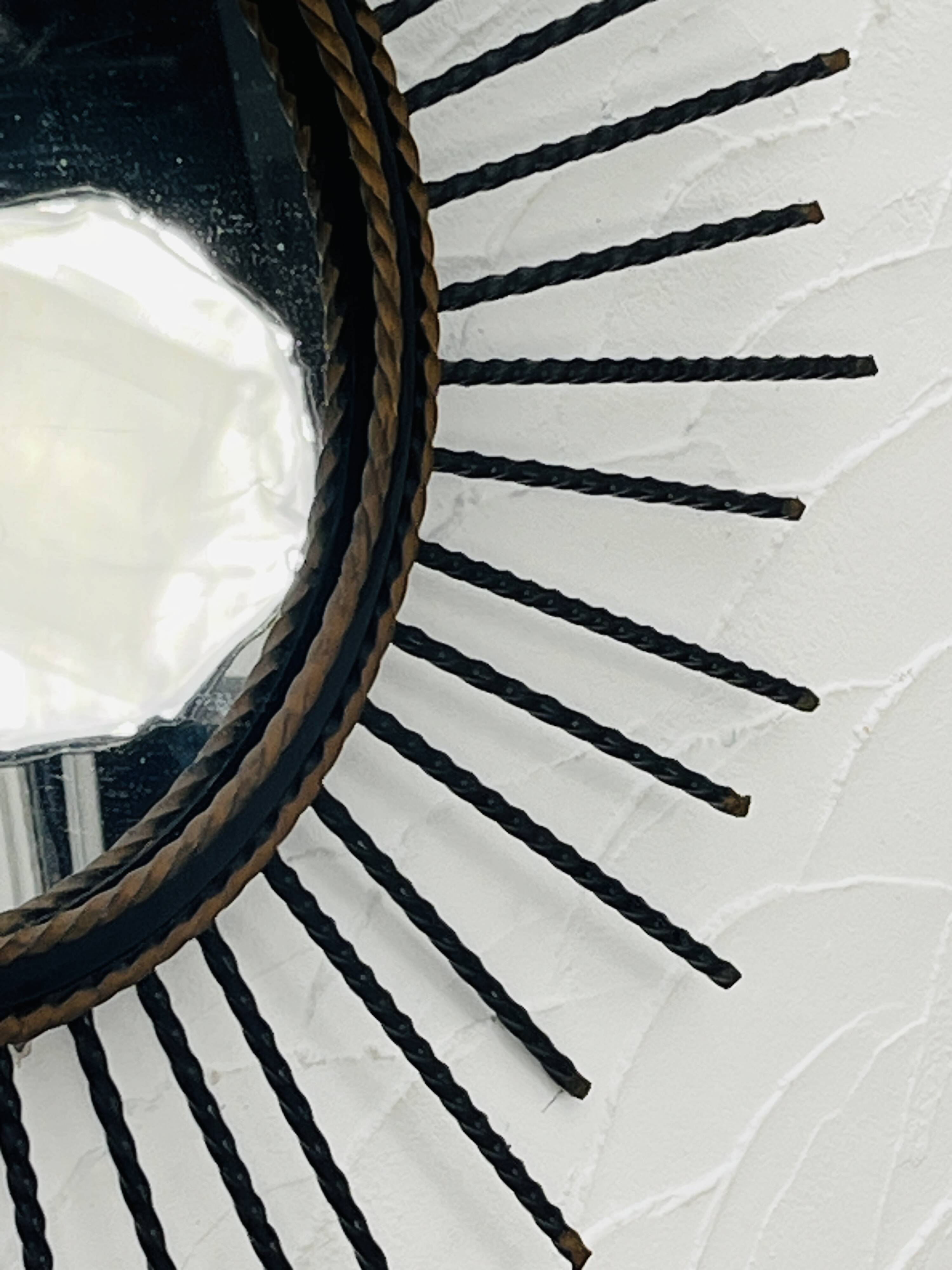 Vintage black and gold metal sun mirror from the 1960s.