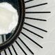 Vintage black and gold metal sun mirror from the 1960s.