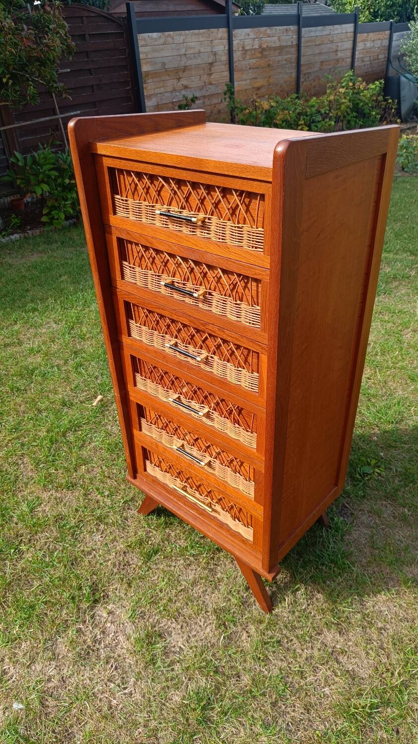 Tall chest of drawers in wood and rattan with splayed legs