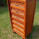Tall chest of drawers in wood and rattan with splayed legs