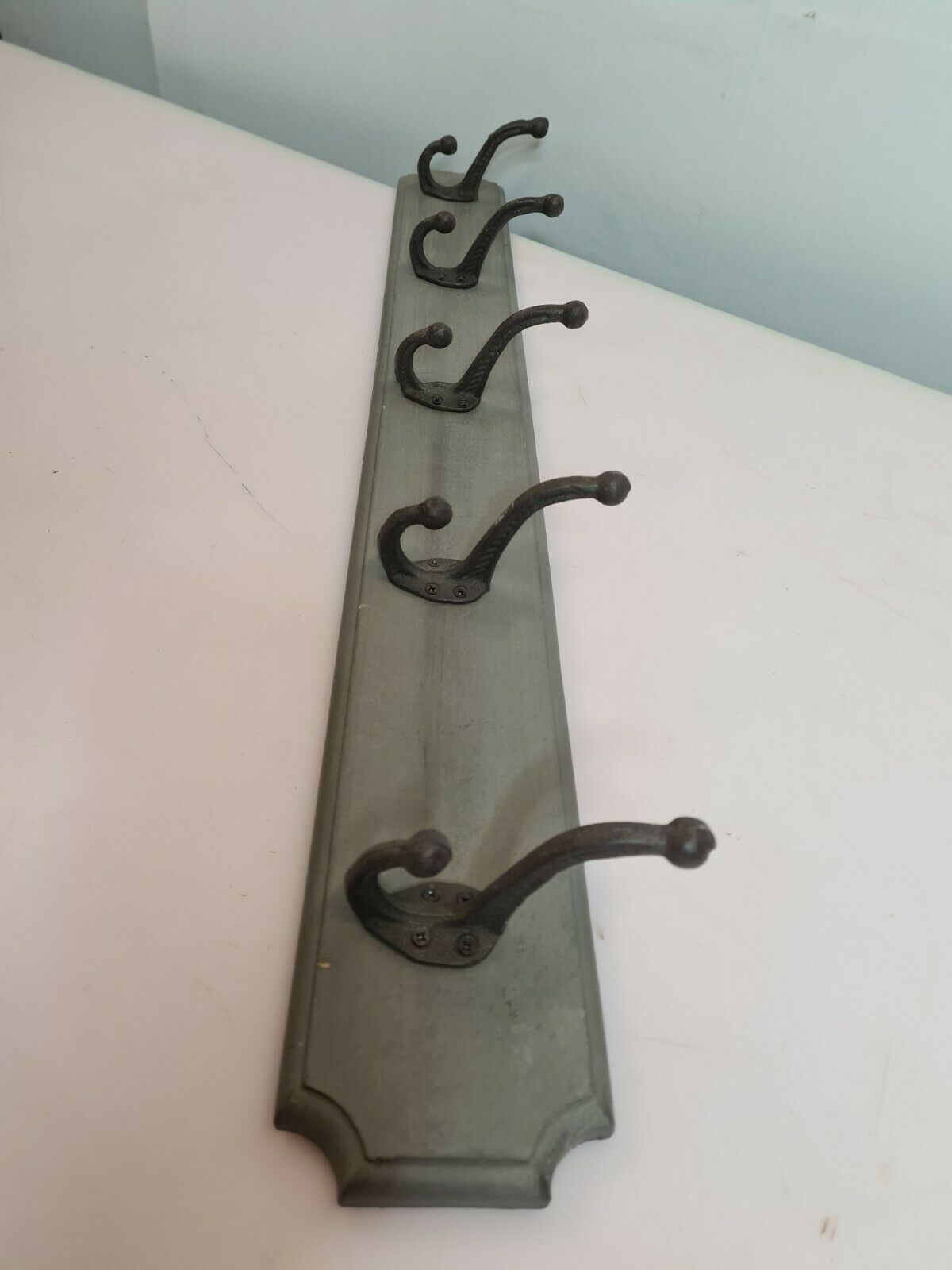 Wooden coat rack with cast iron hooks