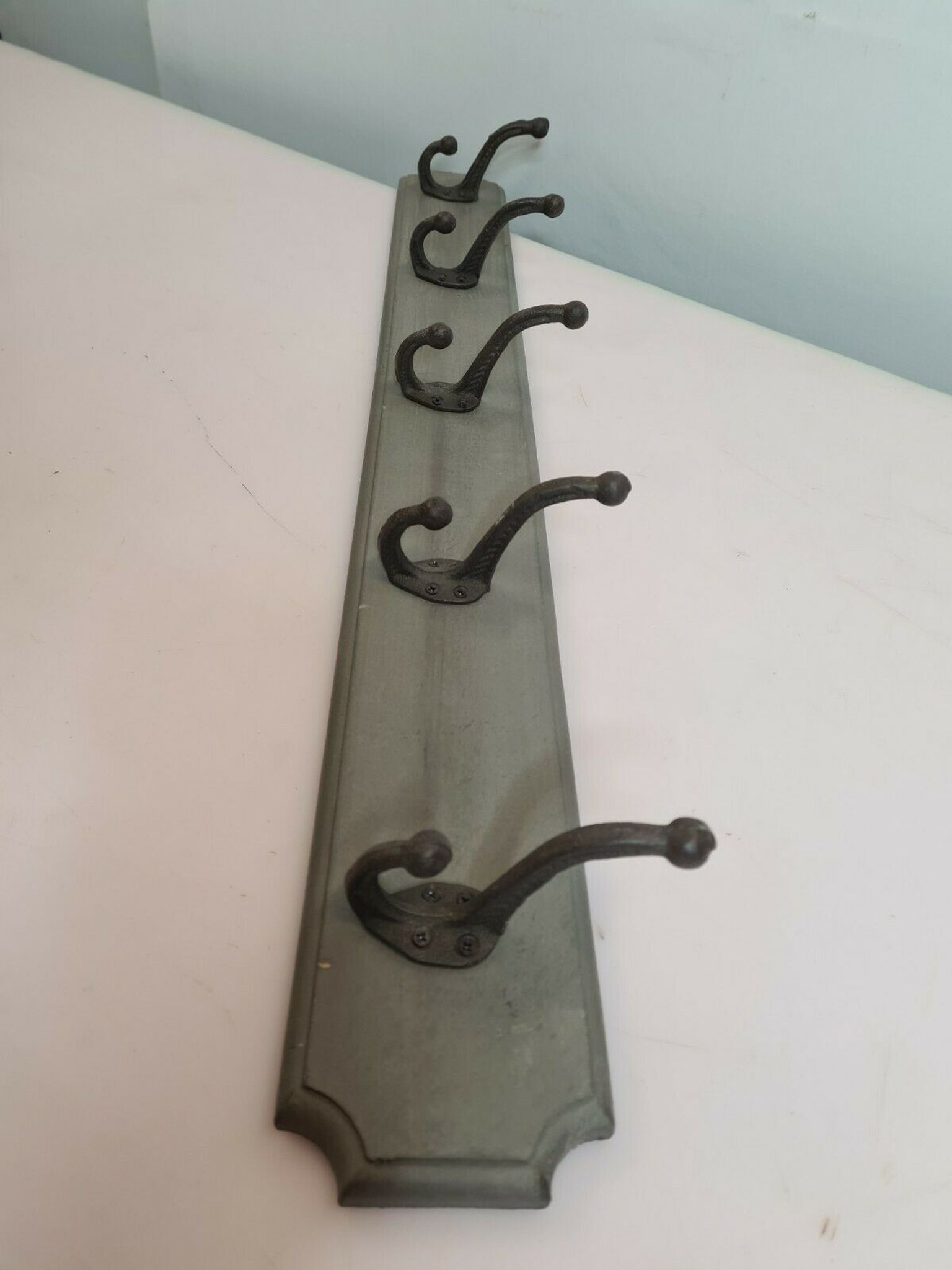 Wooden coat rack with cast iron hooks