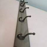 Wooden coat rack with cast iron hooks