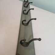 Wooden coat rack with cast iron hooks