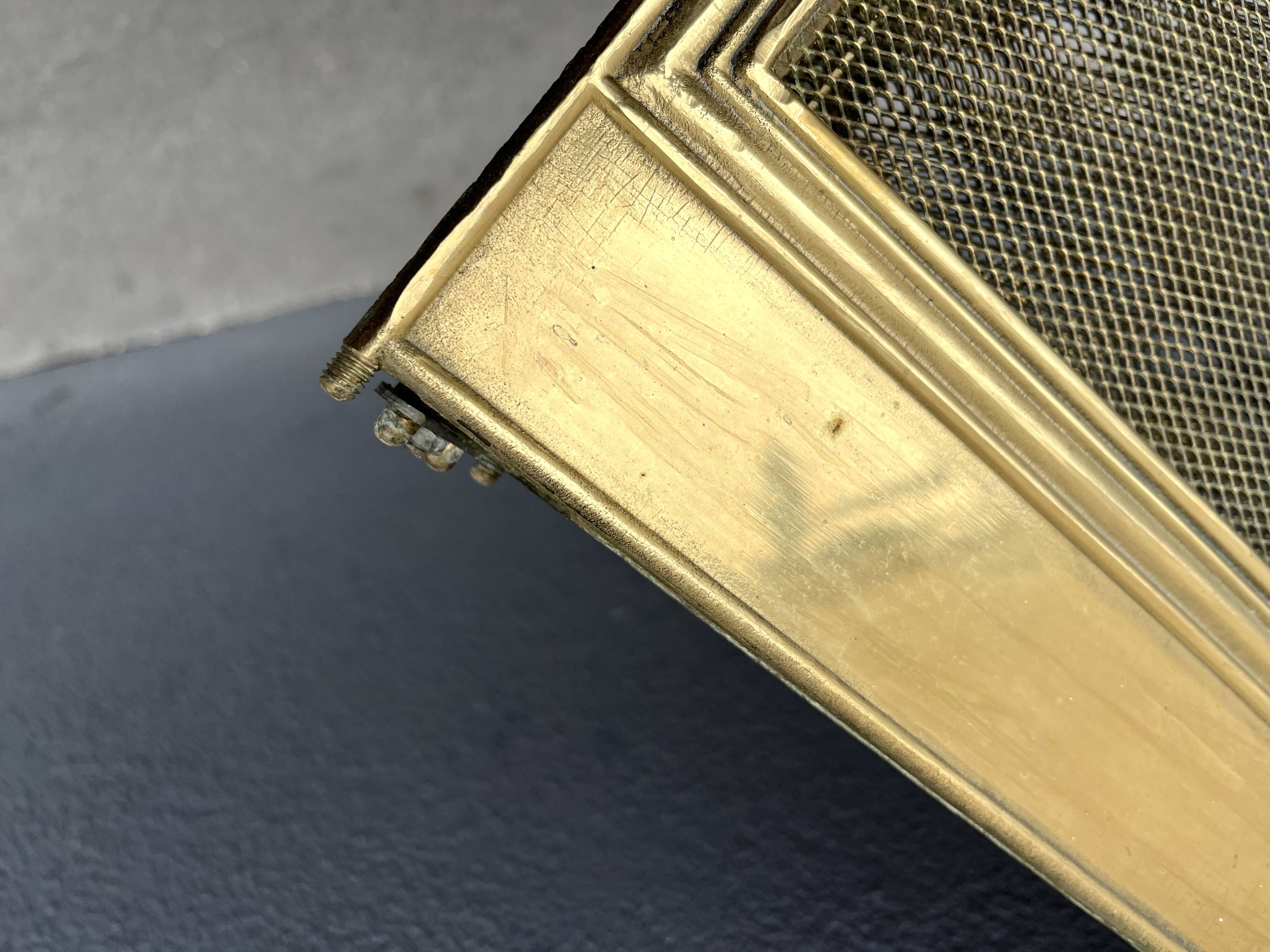 Antique brass fireplace screen from 1920, vintage spark guard.