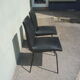 Lot de 2 chaises simili noir par Pierre Guariche