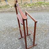 Valet wearing double wood coat rack