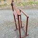 Valet wearing double wood coat rack