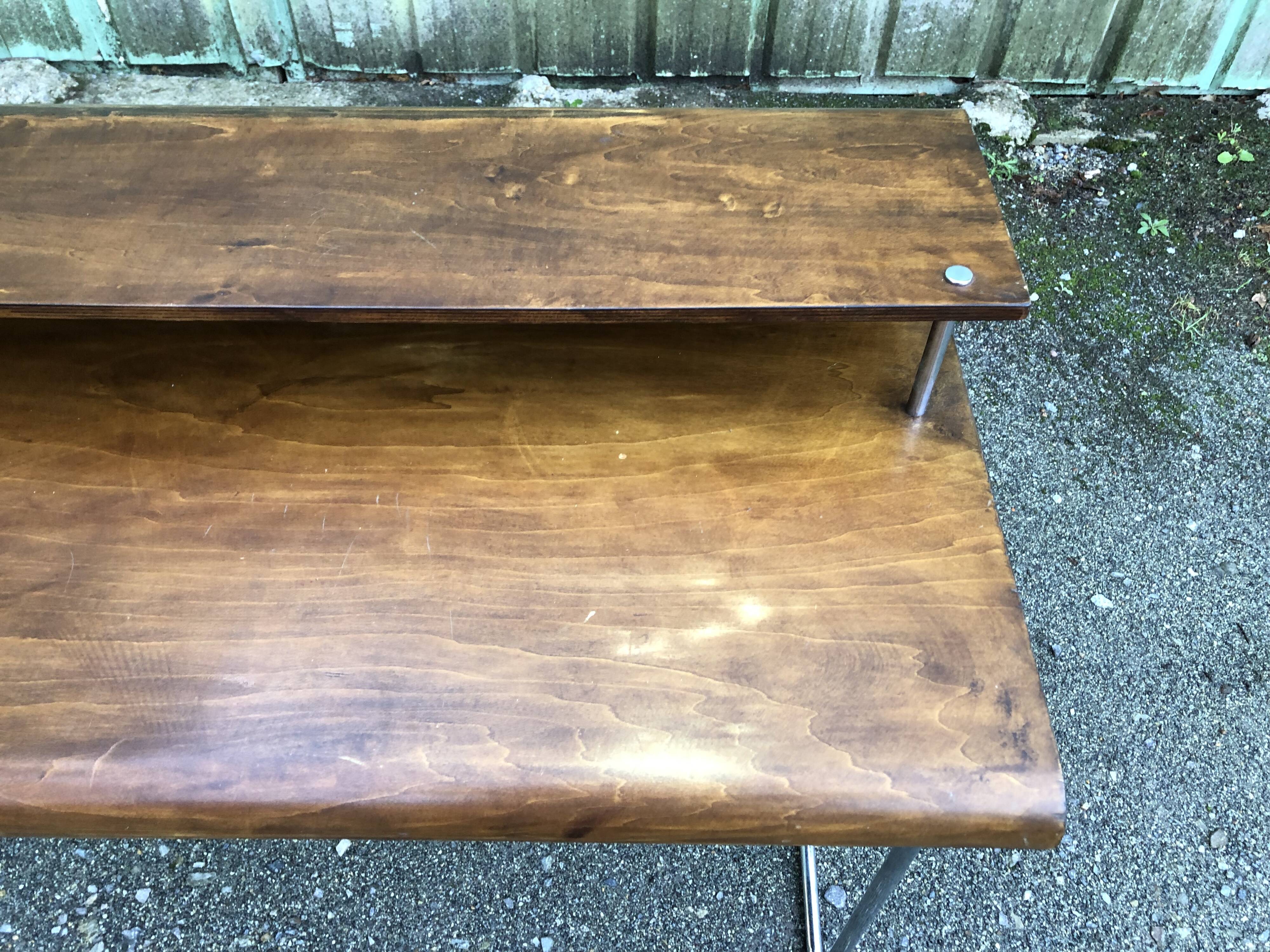 Design desk in formed glued laminated wood with chrome tubular base.