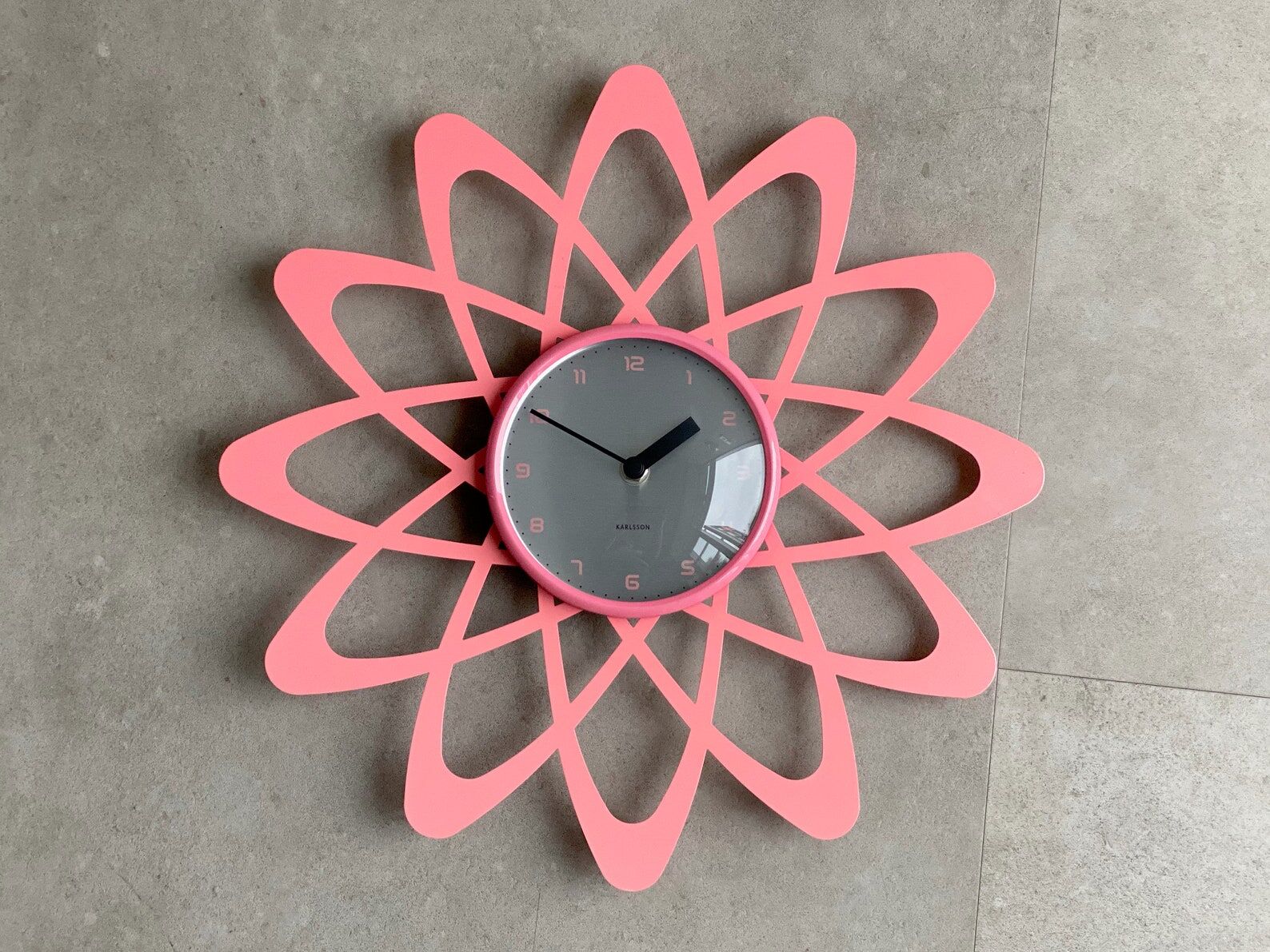 Pink Karlsson wall clock in a mid century shape