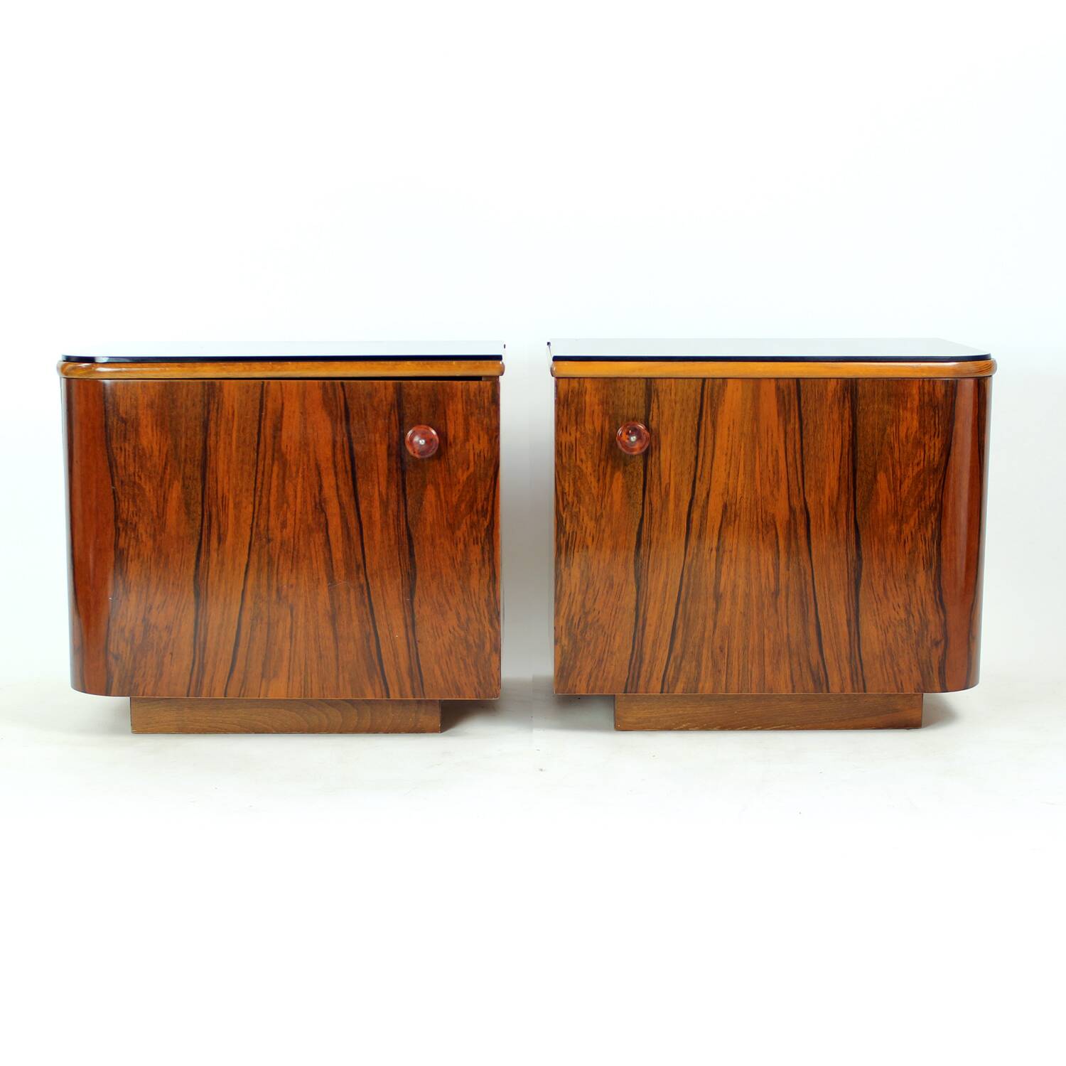 Pair of Art Deco bedside tables in walnut and black glass, Czechoslovakia.