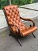Chesterfield armchair in leather and carved solid wood