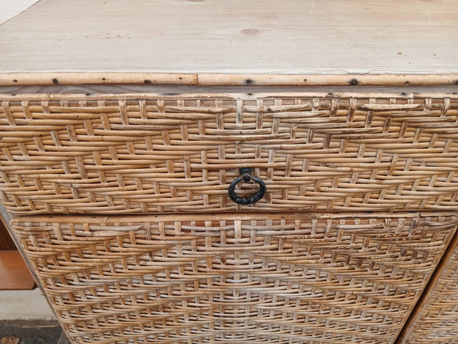Vintage woven rattan furniture with tapered legs.