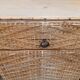 Vintage woven rattan furniture with tapered legs.
