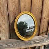 Antique gilded oval mirror