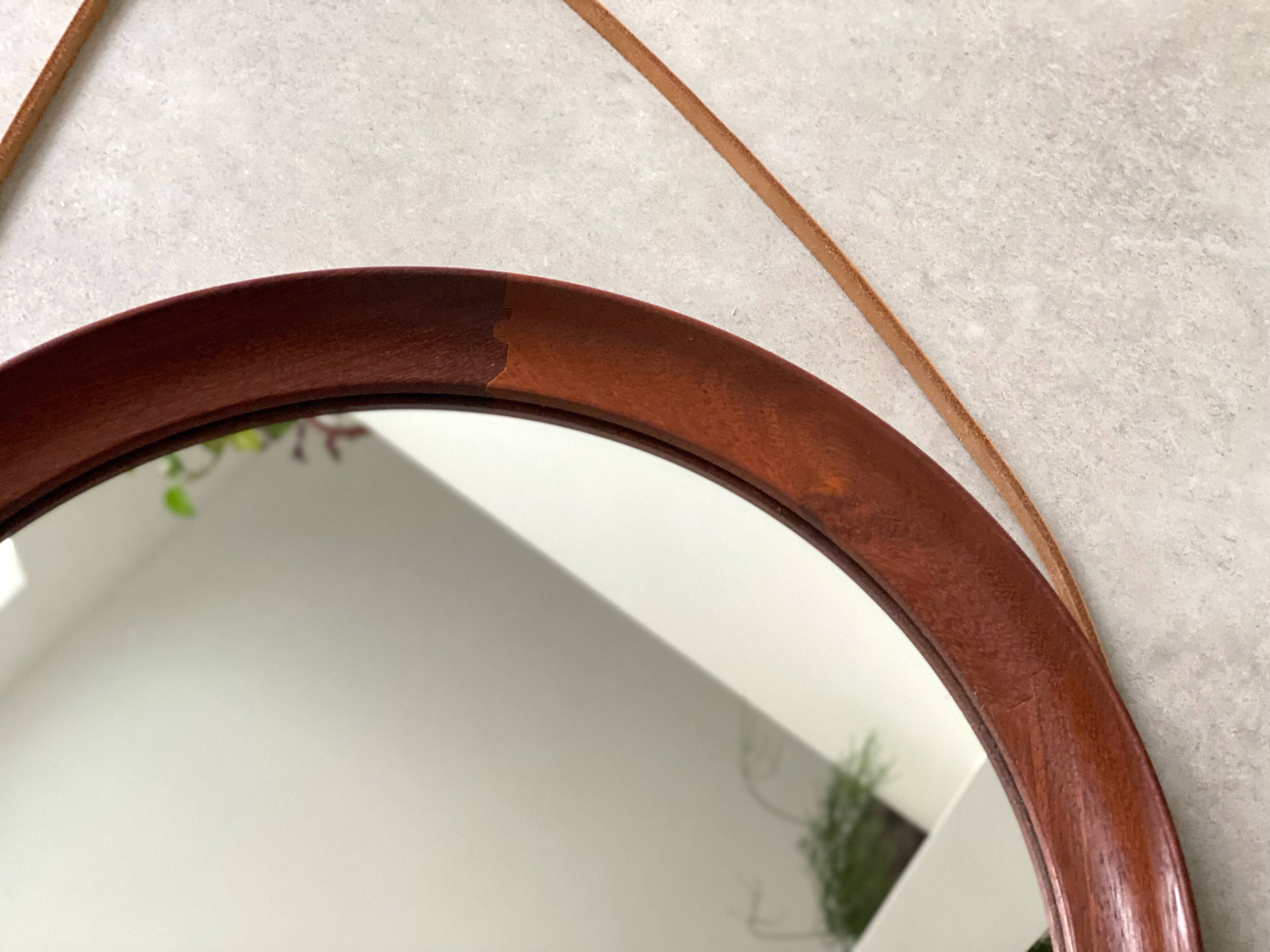 Mid Century solid teak wall mirror with a leather strap - Danish design