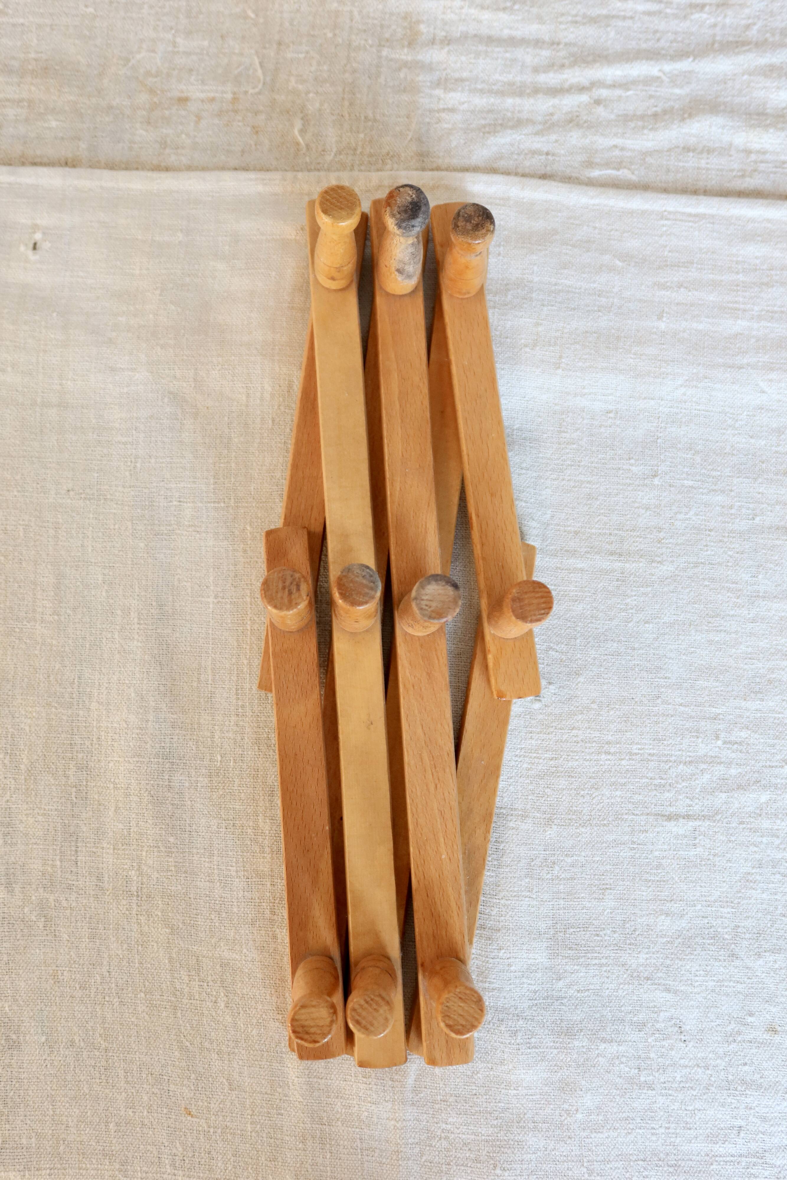Vintage retractable wall-mounted coat rack made of pine wood