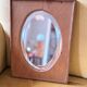 Bevelled oval mirror on oak frame